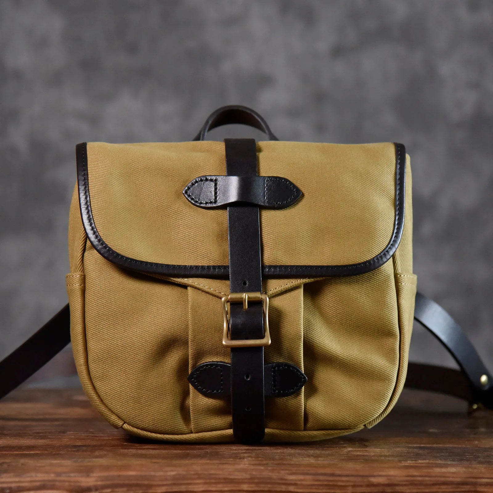 Brown waxed canvas and leather messenger bag full front view