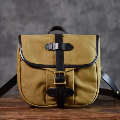 Brown waxed canvas and leather messenger bag full front view