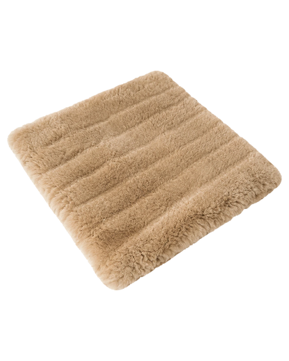 Camel genuine short-pile sheared-sheepskin patchwork chair pad on transparent background