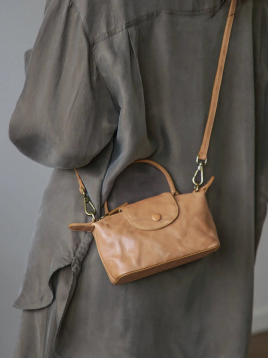 Chestnut vegetable-tanned leather mini bag worn crossbody