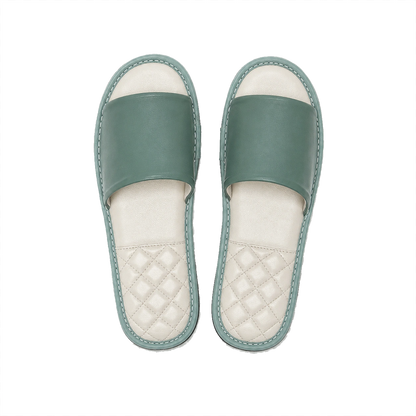 Sage green lambskin leather open-toe slippers with ivory footbeds on a transparent background
