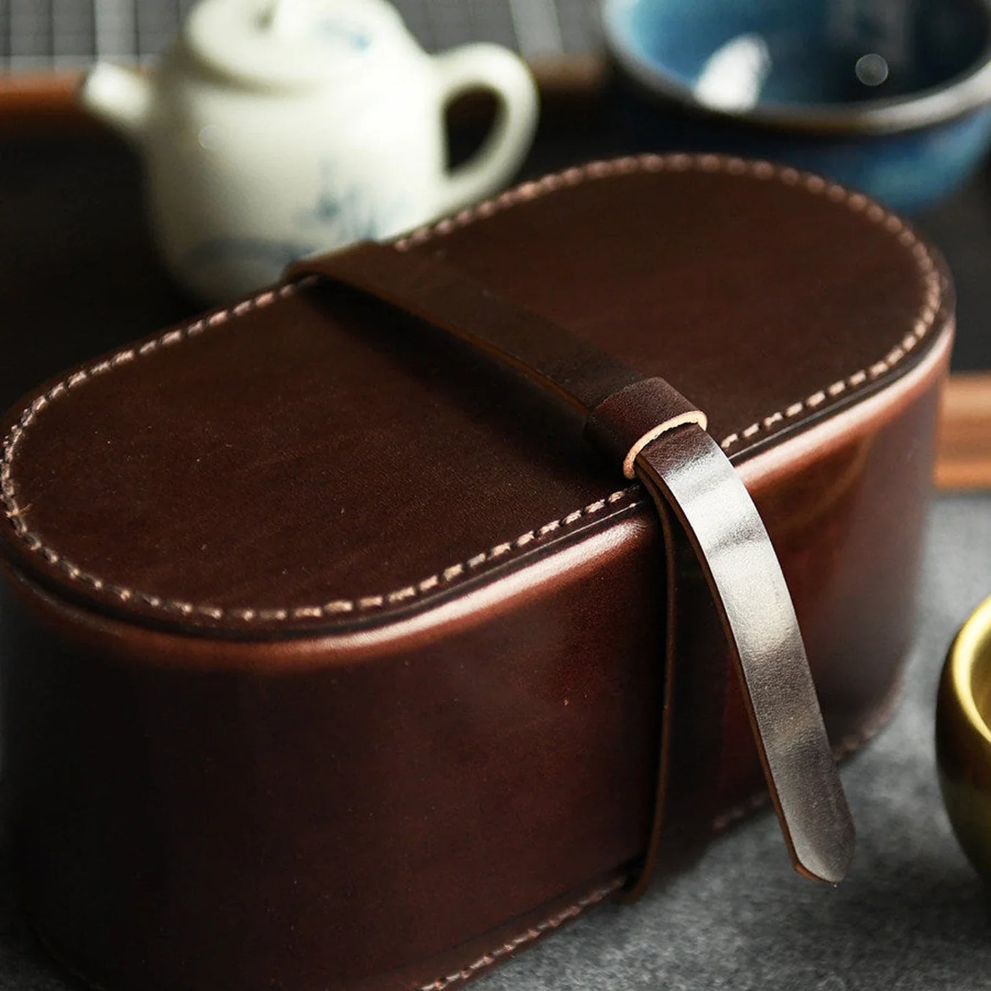 Dark brown vegetable-tanned leather tea case with teaware