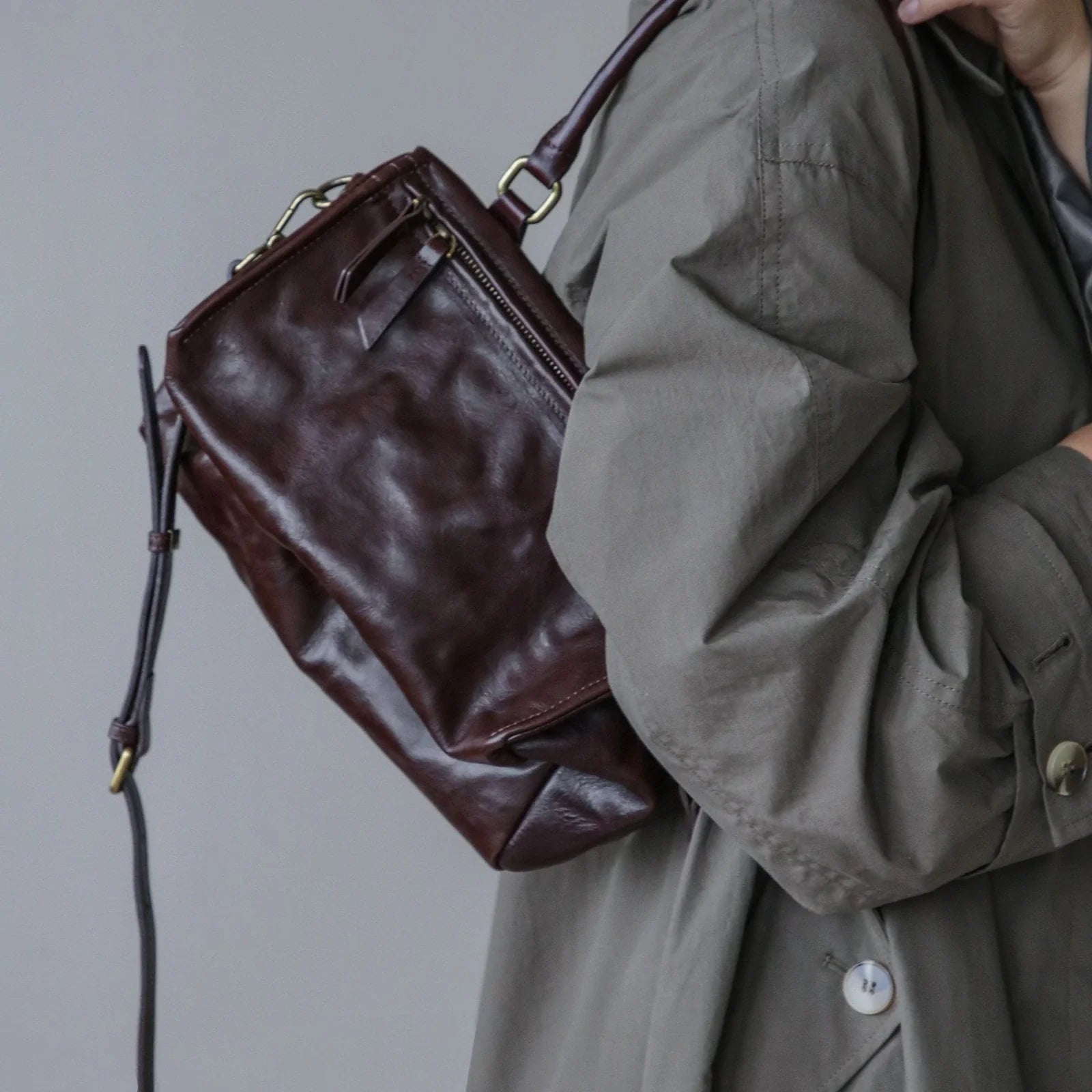 Ebony Brown vegetable-tanned leather bag styled over the shoulder
