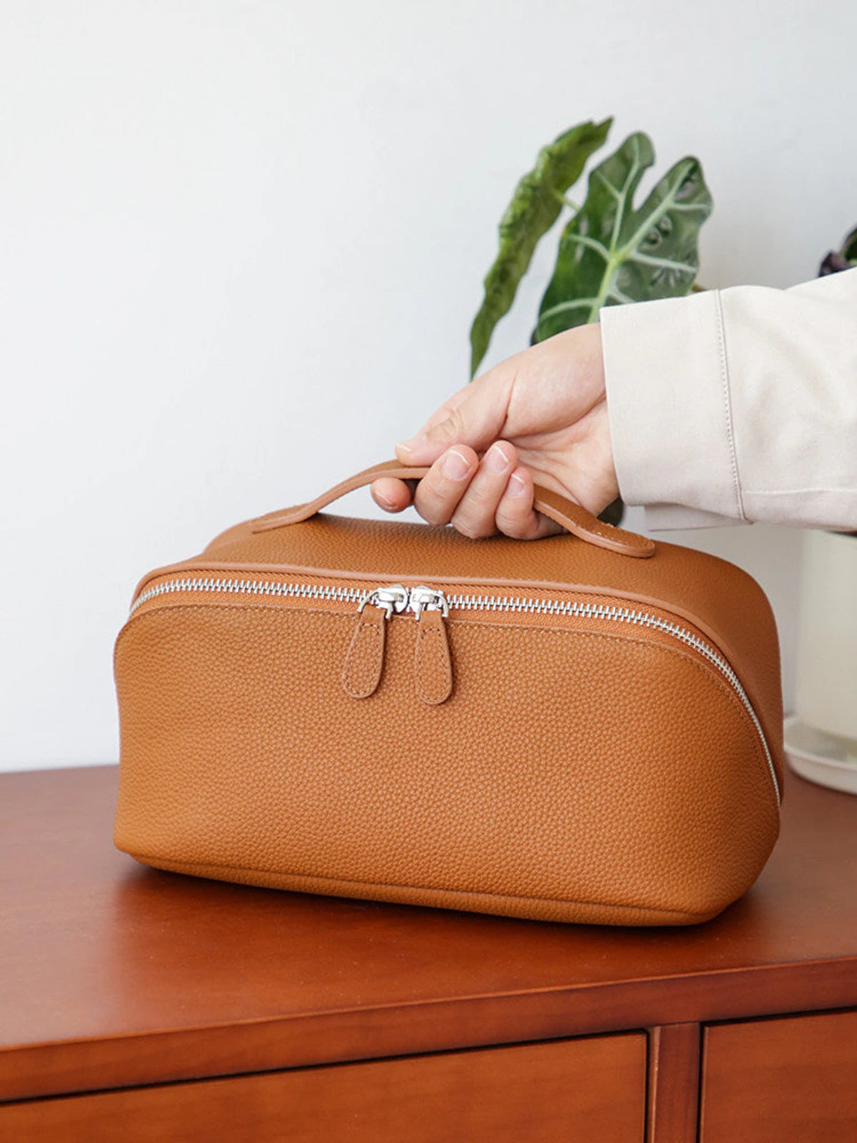 Golden brown top-grain cowhide leather cosmetic travel case with zipper and handle
