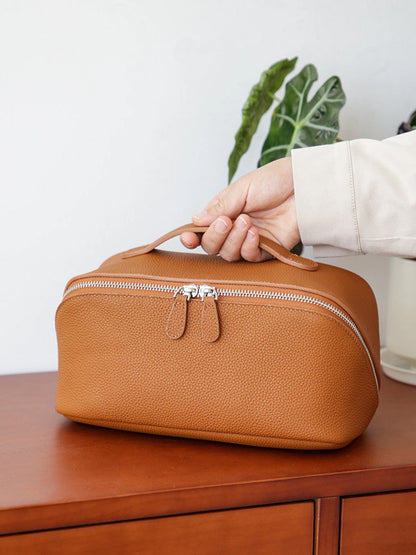 Golden brown top-grain cowhide leather cosmetic travel case with zipper and handle