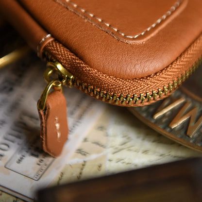 Close-up of contrast stitching and brass-tone zipper on a leather key case