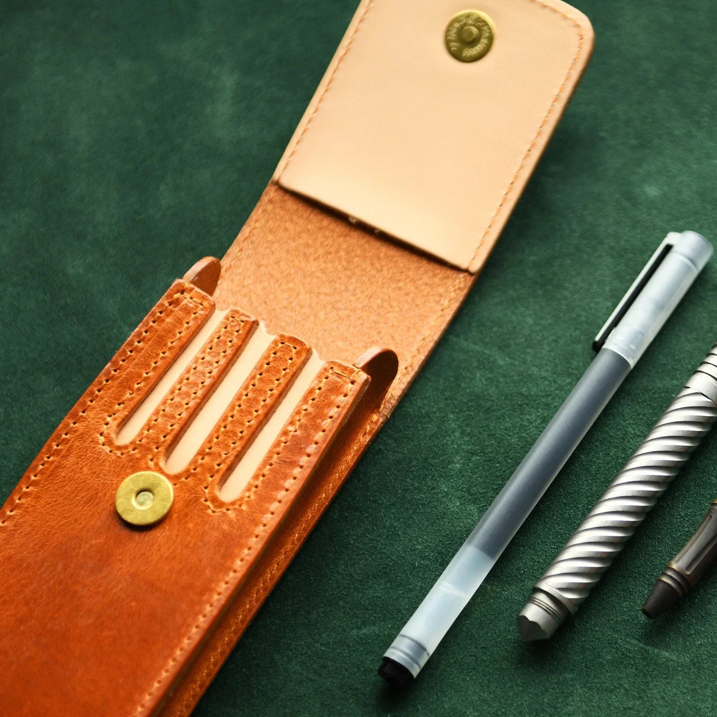 Open leather fountain pen case showing organized pen storage