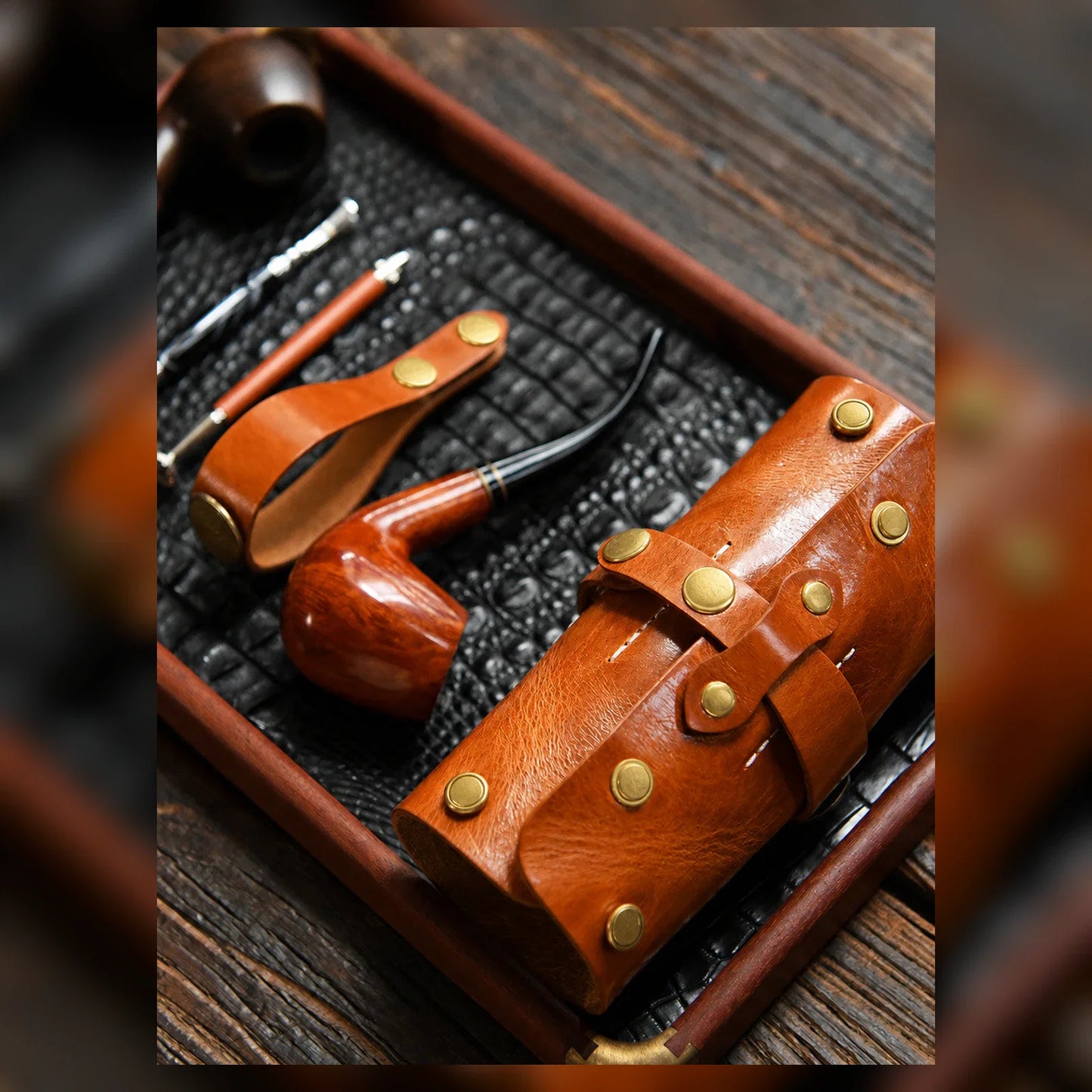 Cognac leather pipe pouch arranged with tobacco pipe accessories