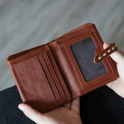 Brown leather wallet opened to show card slots and identification window