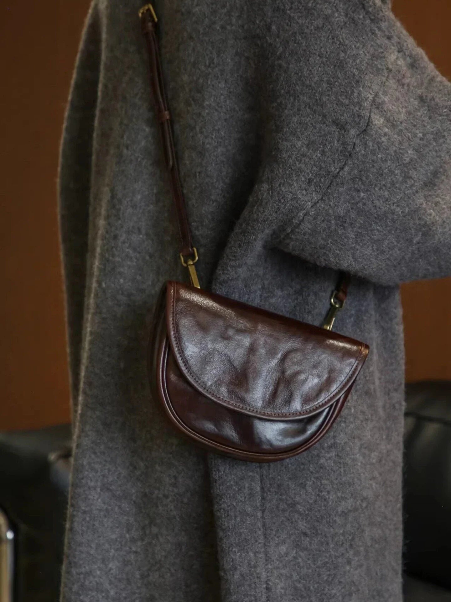 Ebony brown top-grain cowhide saddle bag worn crossbody
