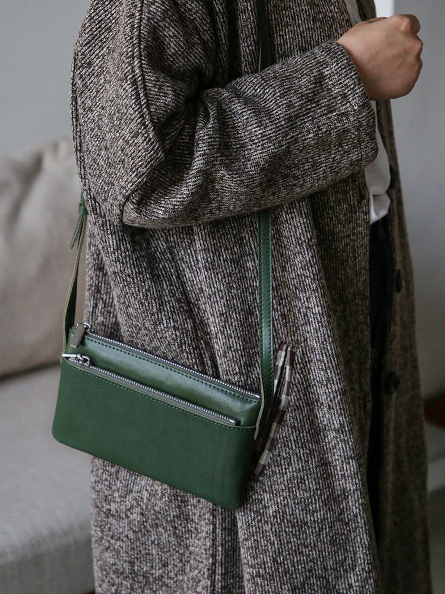 Forest green top-grain leather slim phone bag worn crossbody