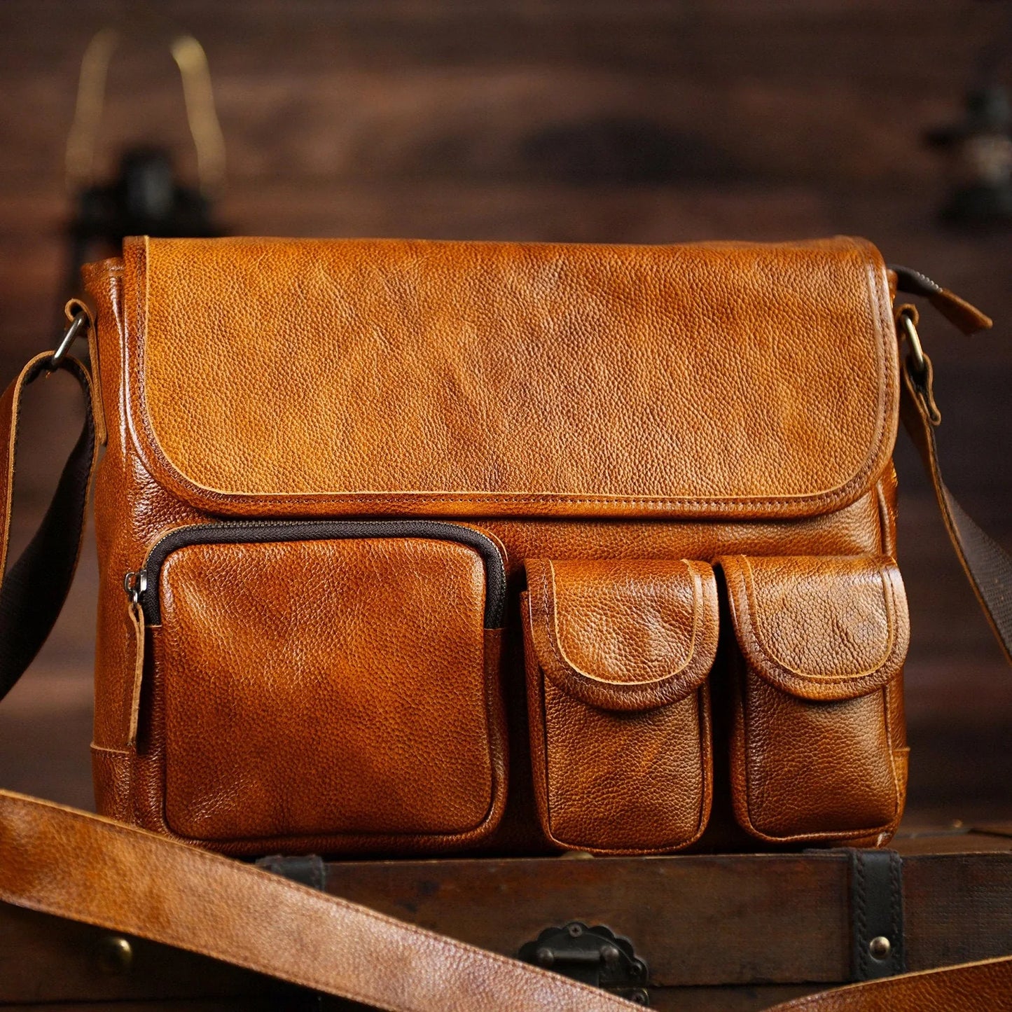 Vintage brown cowhide messenger bag front and leather grain detail