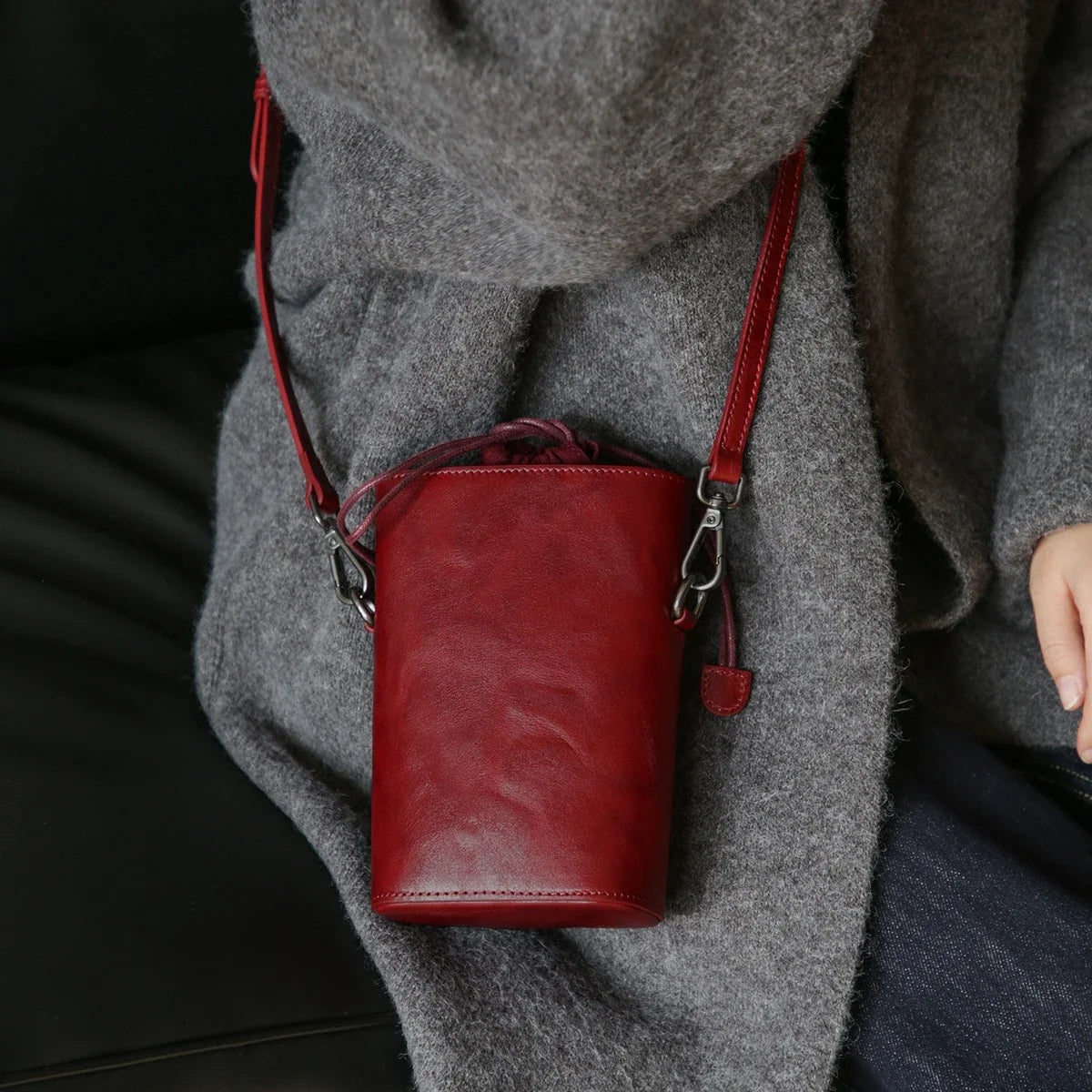 Women's vintage red leather phone bucket bag worn crossbody