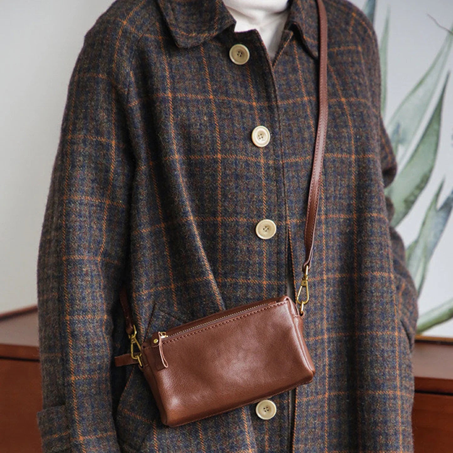 Front view of the coffee brown top-grain leather crossbody bag