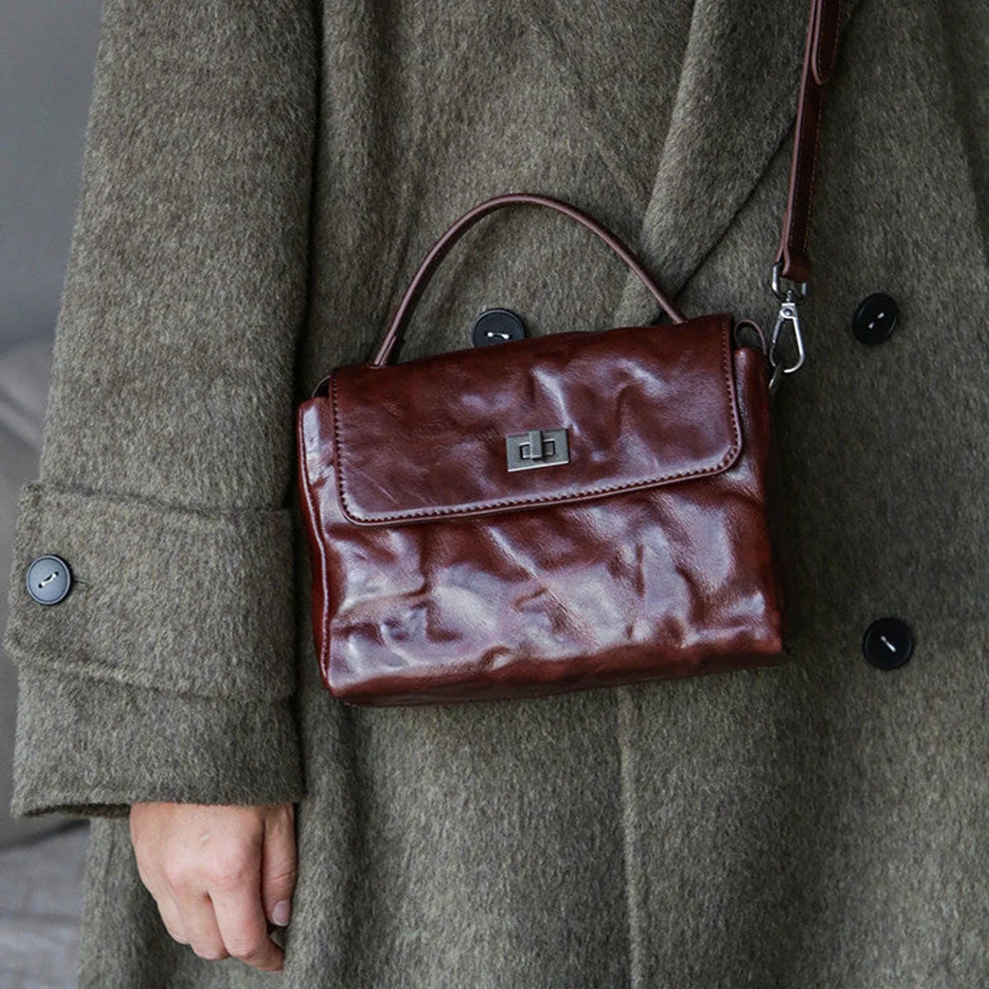 Chestnut brown leather satchel worn crossbody