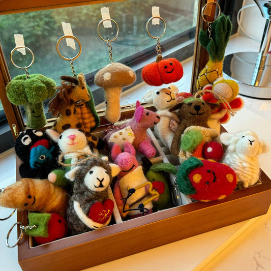 Colorful handmade wool felt animal charms displayed together