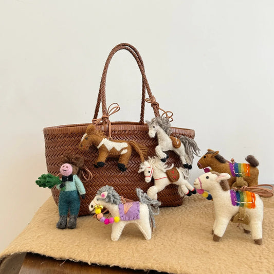Wool felt horse charms on a woven tote bag