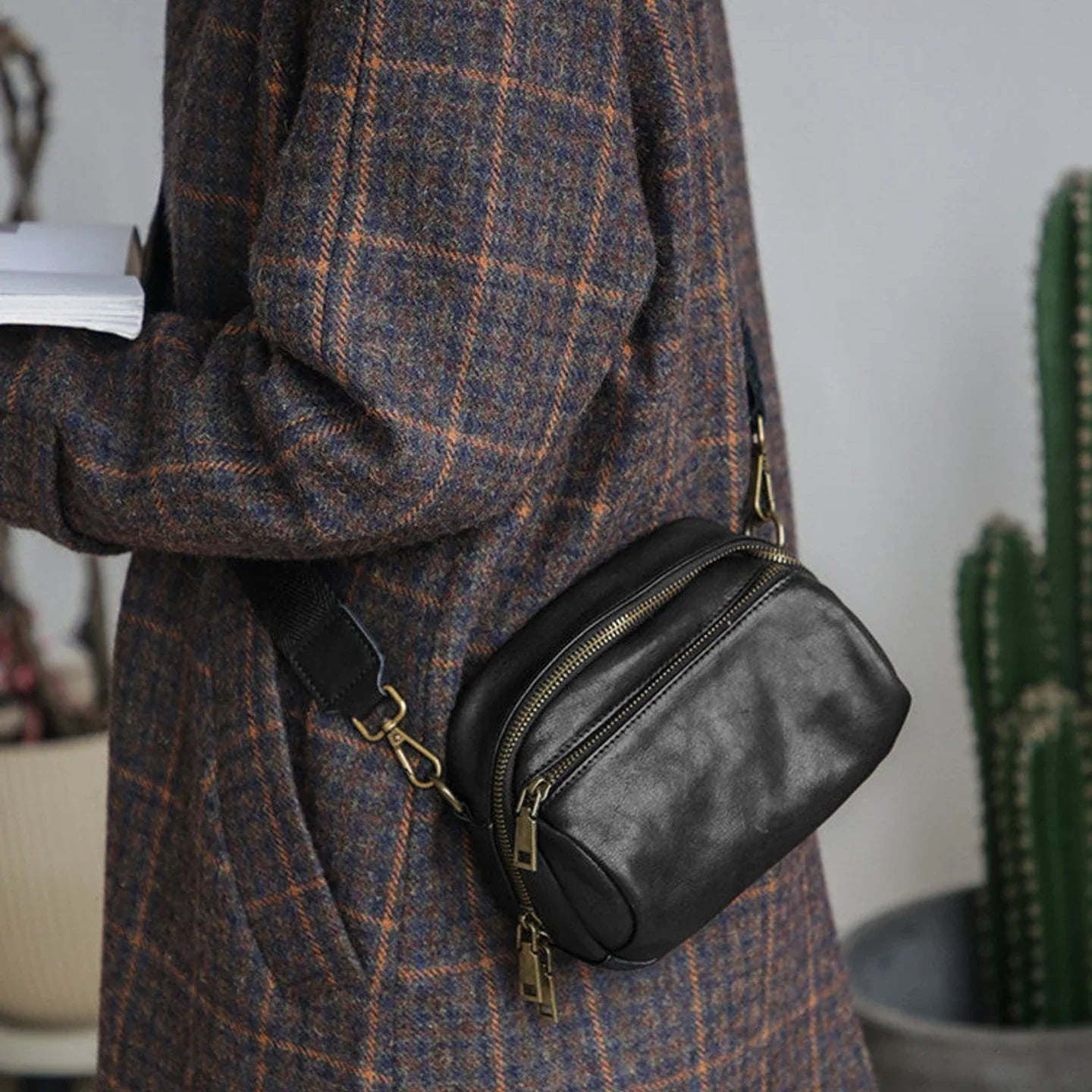 Women's black top-grain leather crossbody bag with front zip compartments