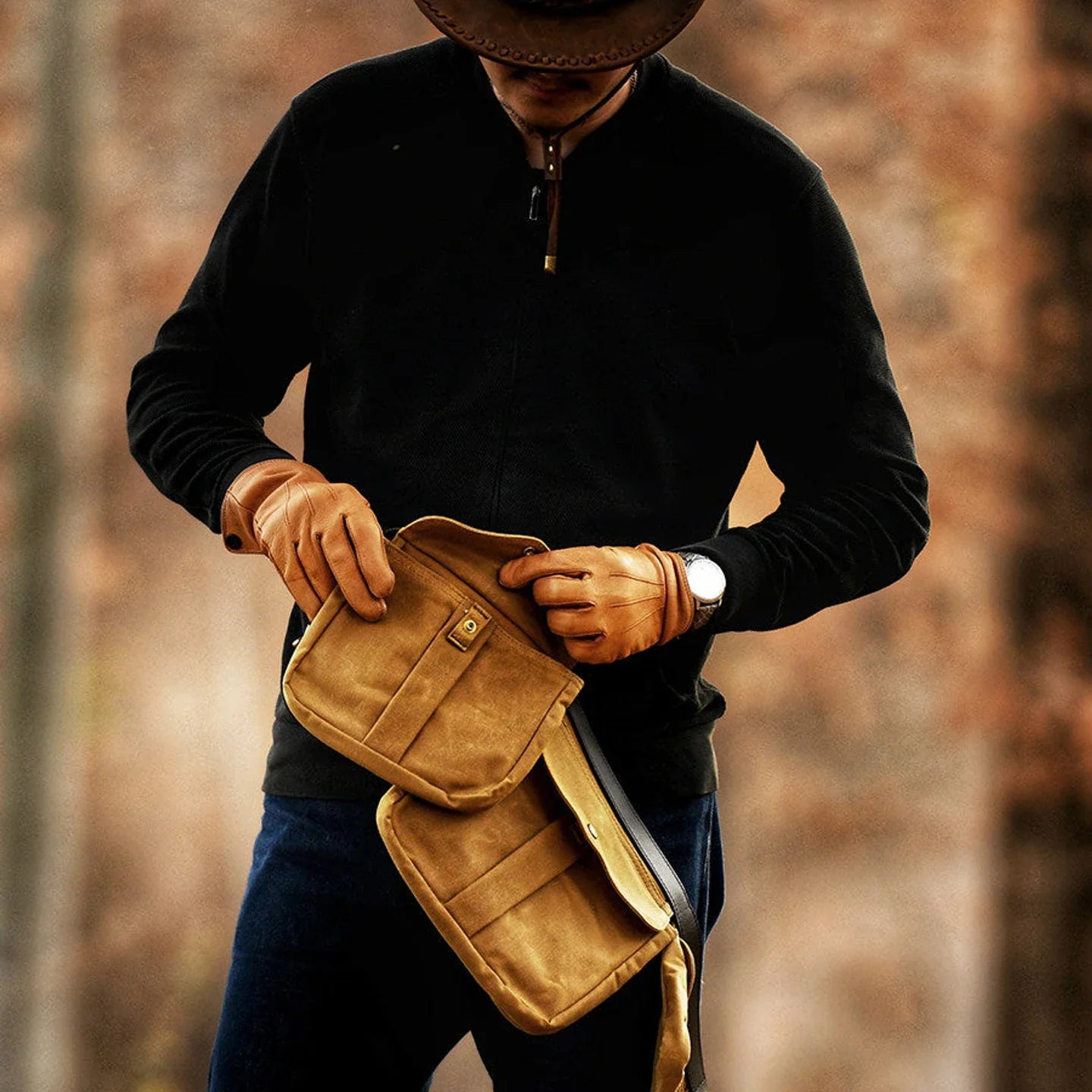 Canvas waist bag being adjusted to show its flexible multi-pocket design