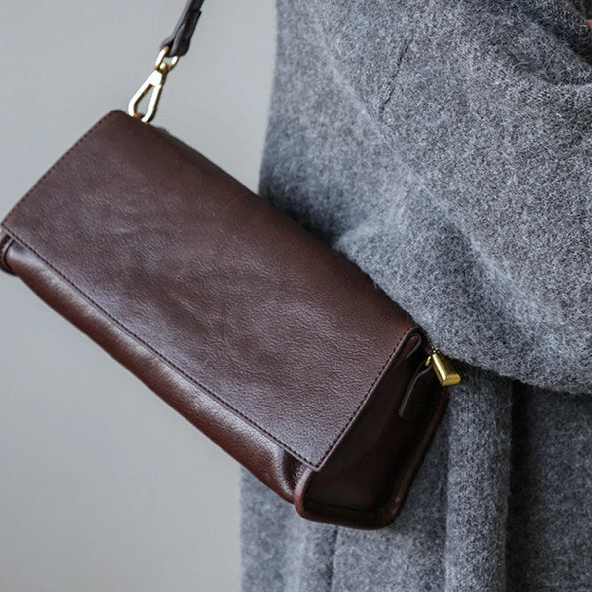 Coffee brown leather flap, grain, and gold-tone hardware detail