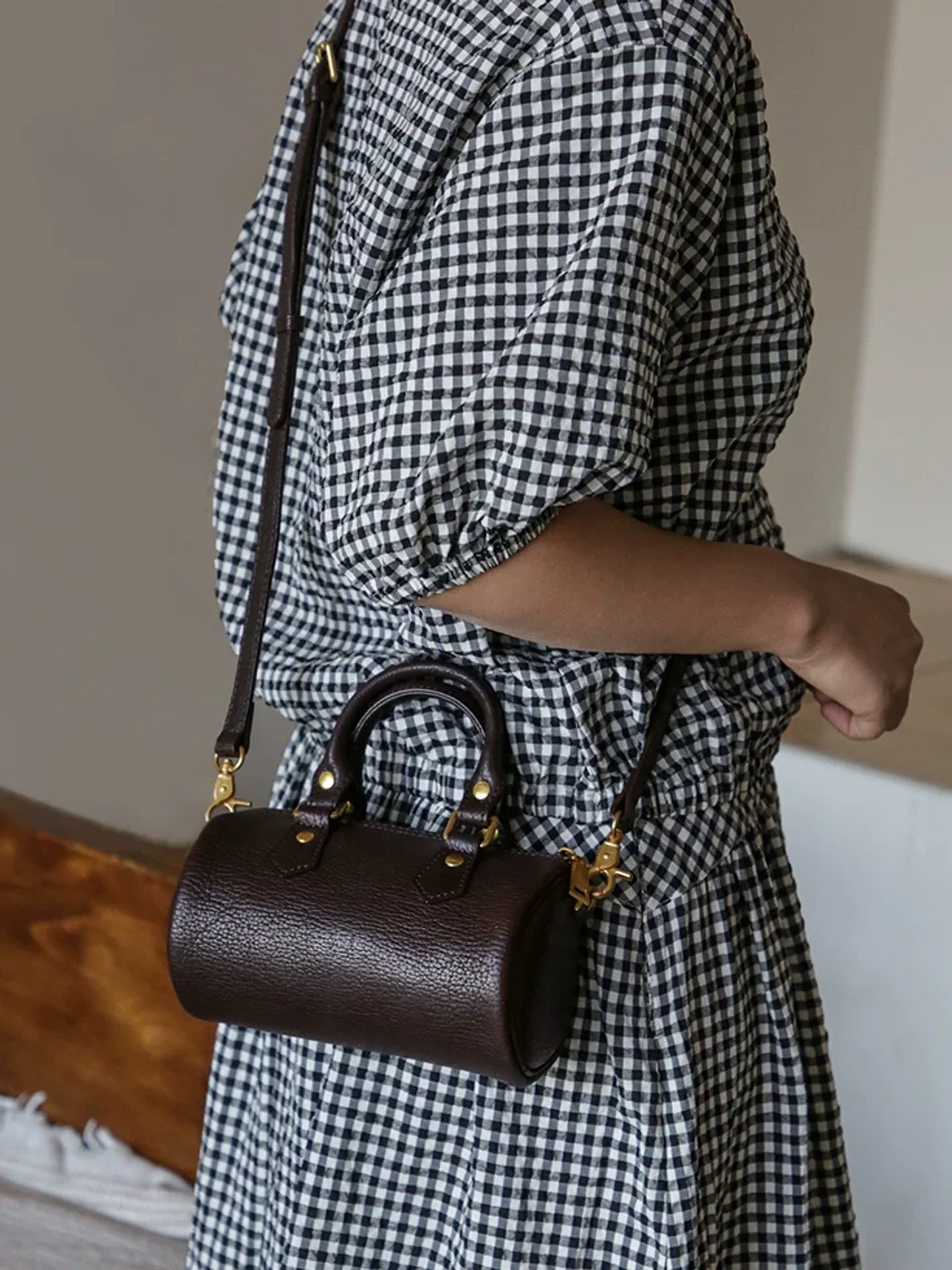 Coffee brown leather barrel bag with top handles and detachable strap