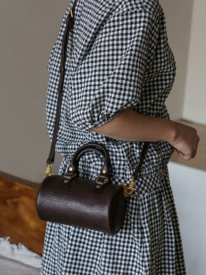 Coffee brown leather barrel bag with top handles and detachable strap