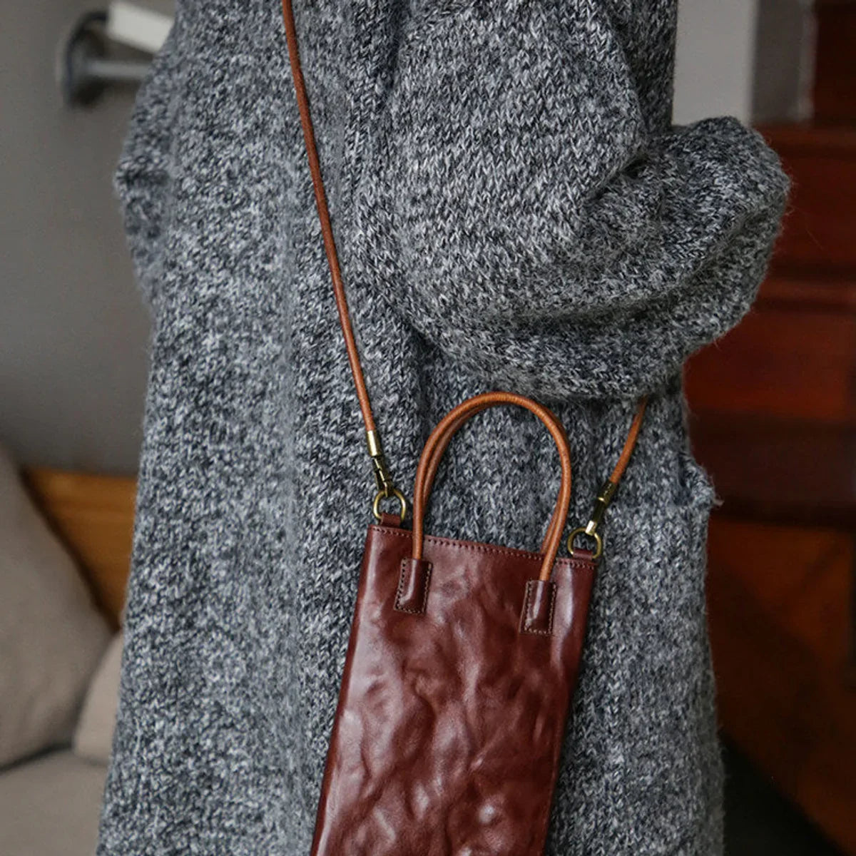 Coffee brown leather mini tote bag worn crossbody