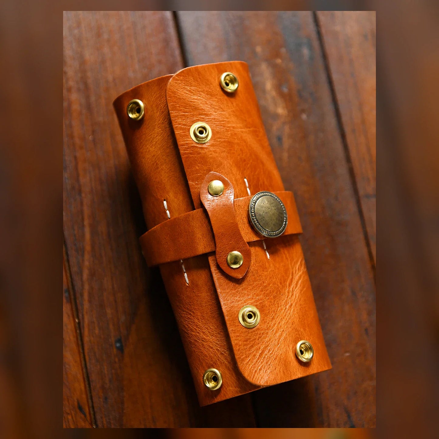 Cognac brown hand-stitched leather pipe pouch closed