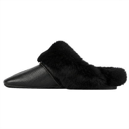 Black genuine cowhide and rabbit fur mule slipper side view on a transparent background
