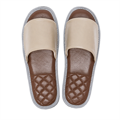 Stone gray lambskin leather open-toe slippers with brown footbeds on a transparent background