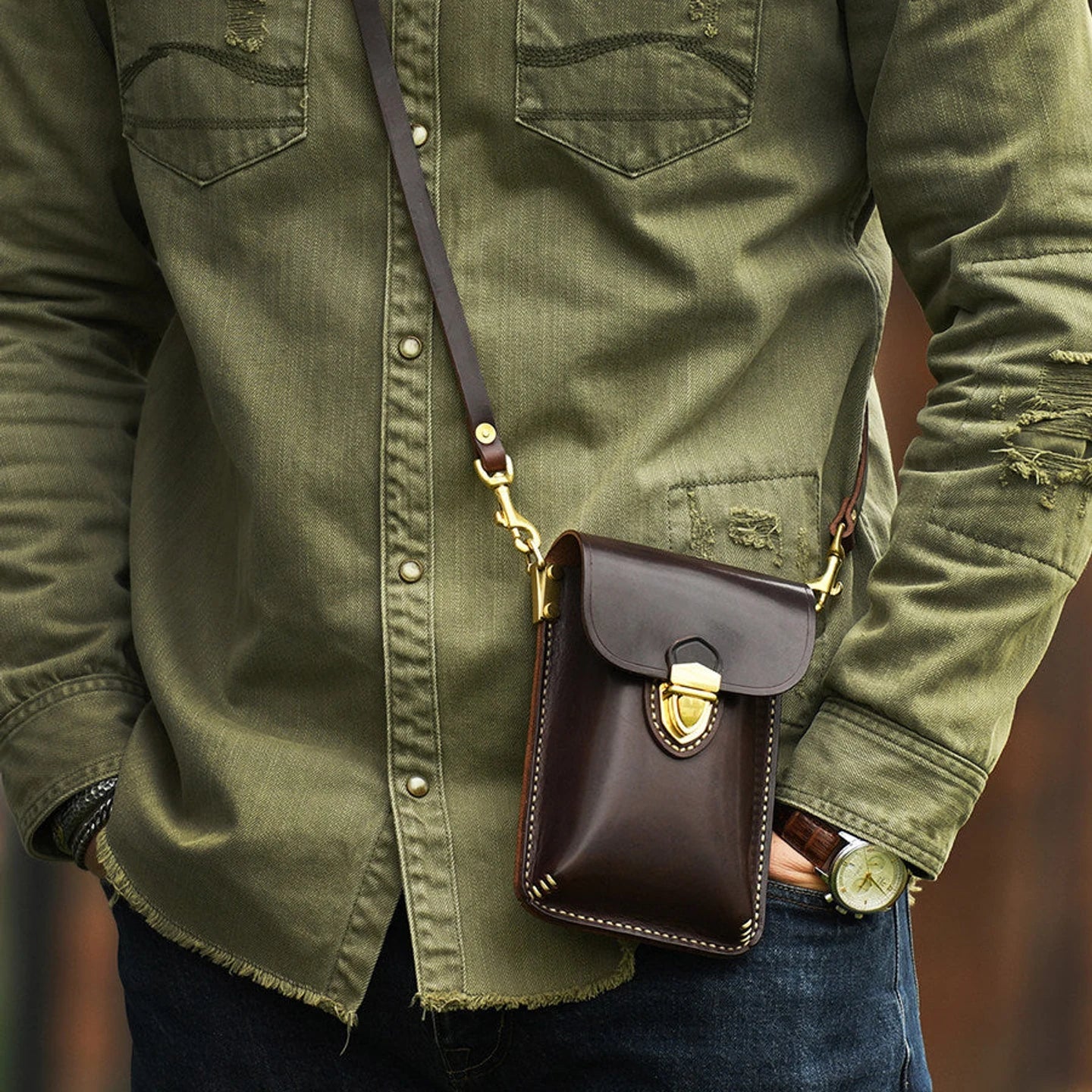 Dark Brown leather phone bag worn crossbody at the front