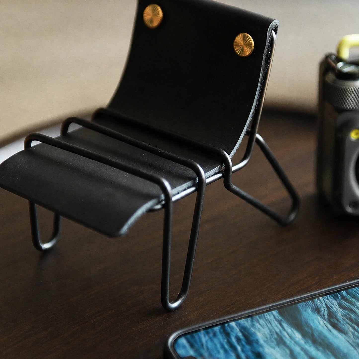 Black leather chair phone stand with black metal frame
