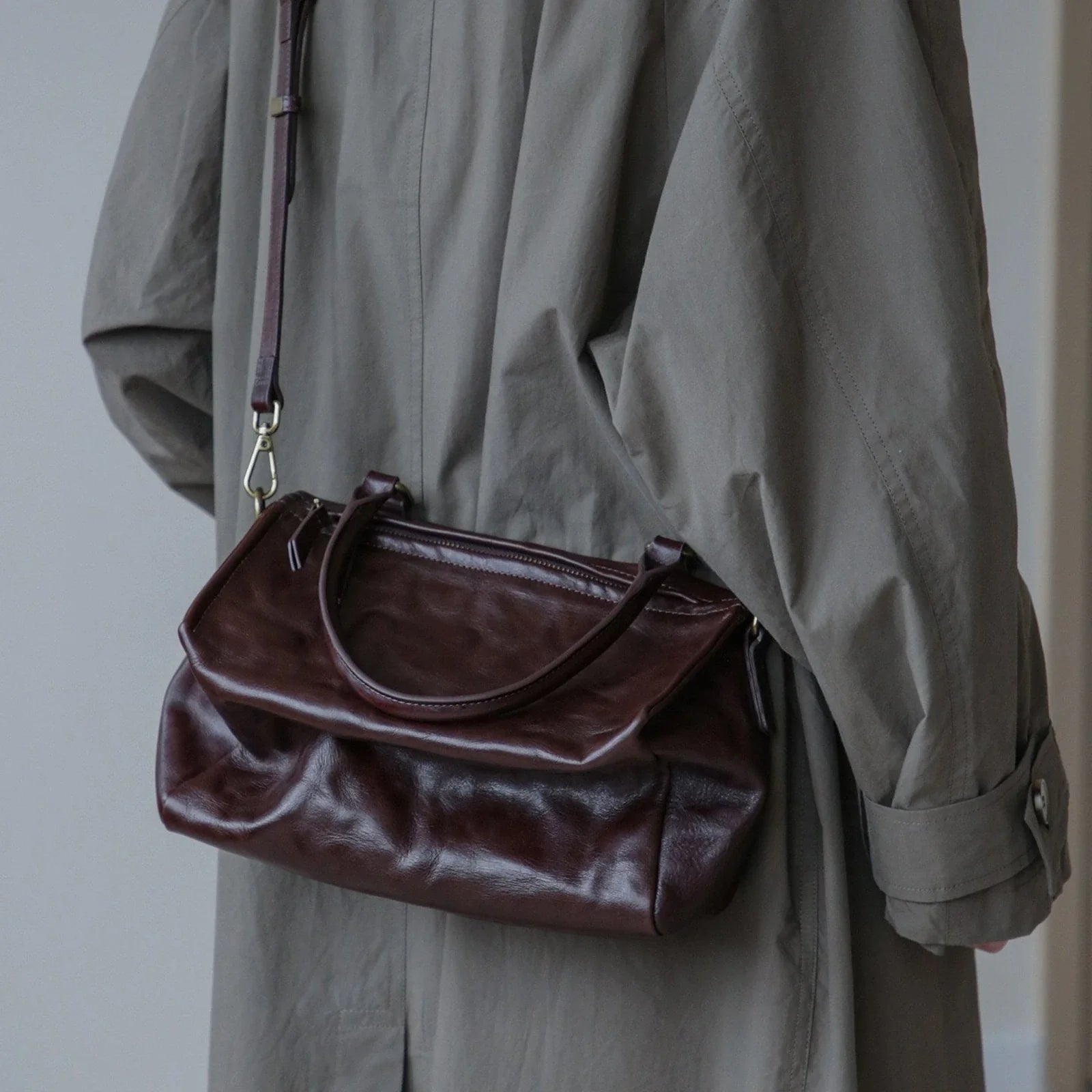Ebony Brown vegetable-tanned leather bag carried by the top handle