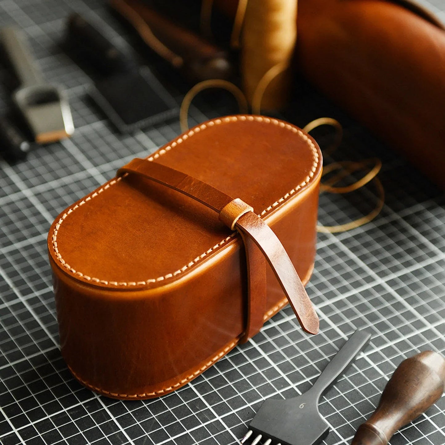 Handcrafted leather tea case photographed in a leather workshop