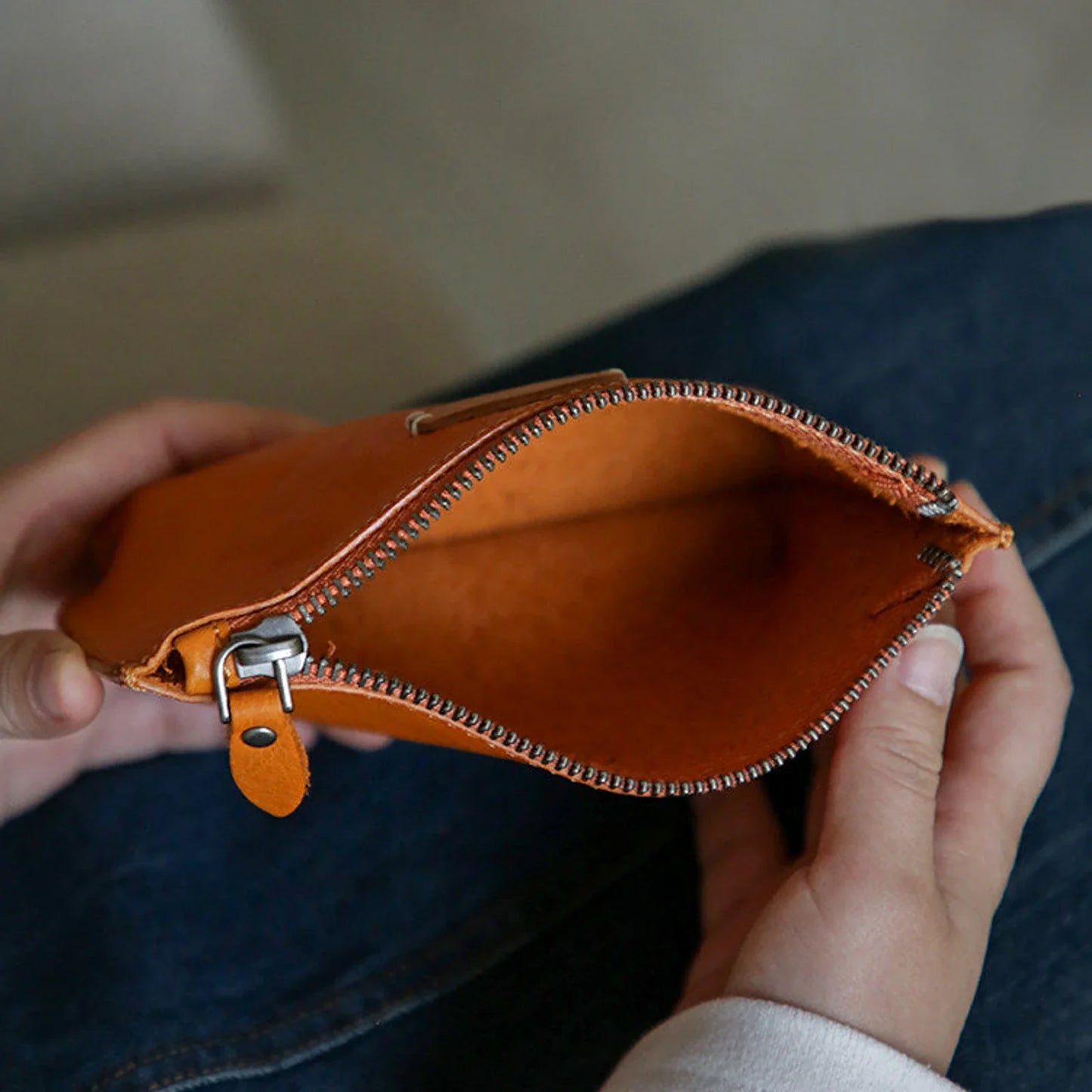 Open sunset yellow leather cosmetic pouch showing the zipper and interior