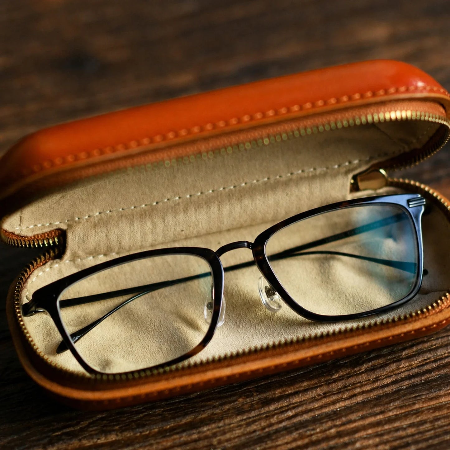 Open vegetable-tanned leather eyeglass case with protective interior