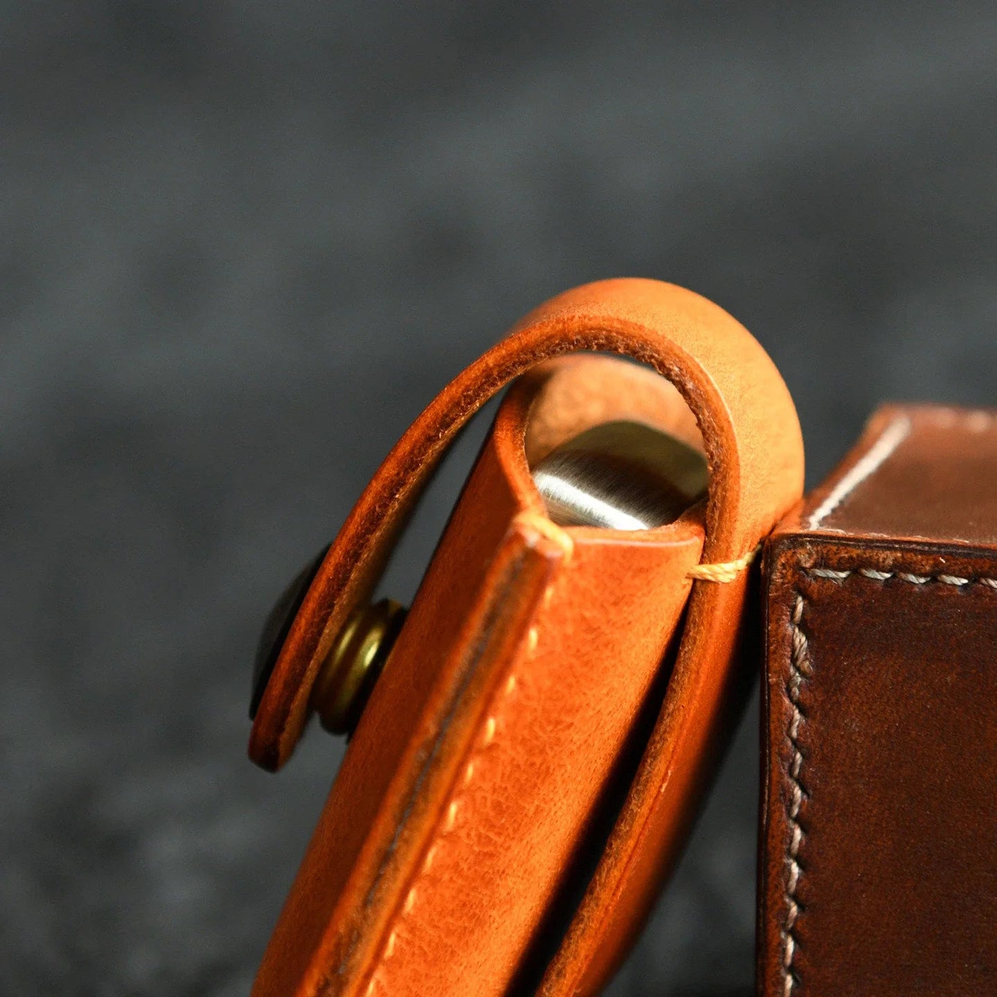 Side profile of a leather lighter case with integrated belt loop