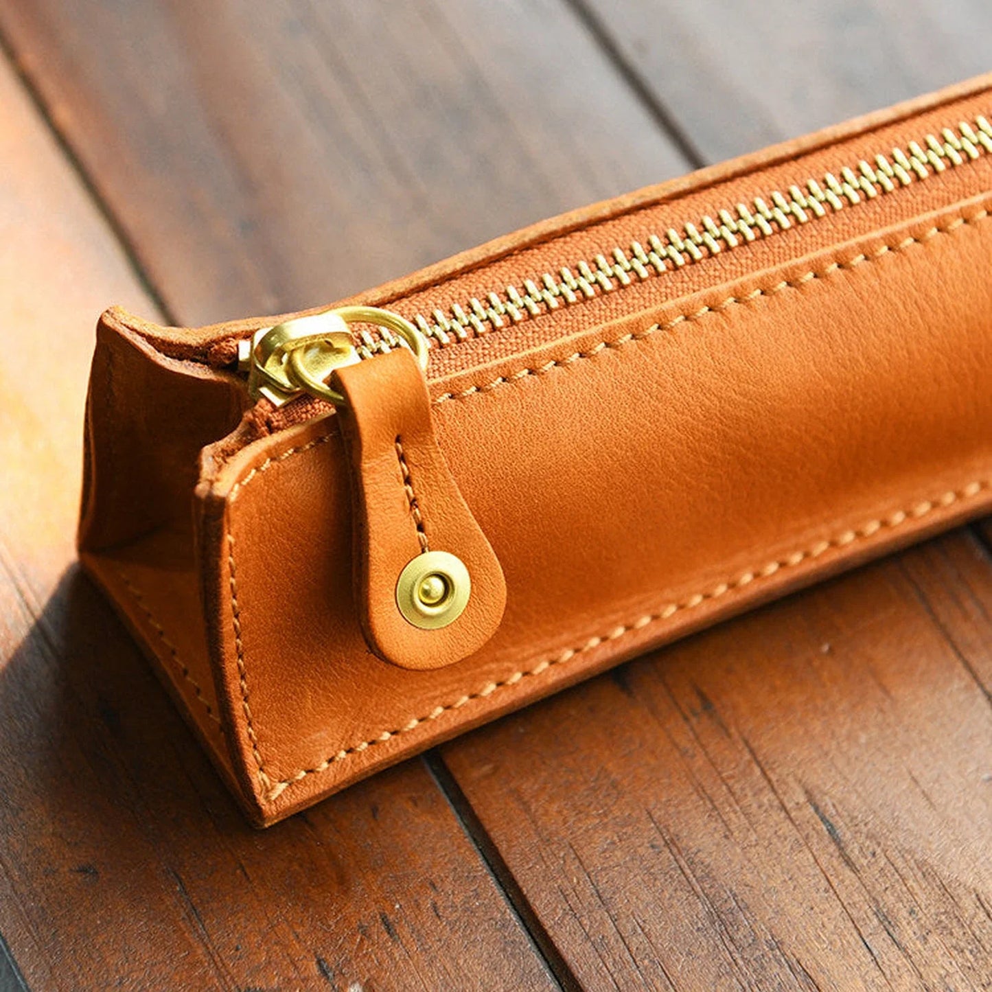 Tan leather pencil case zipper and stitching detail