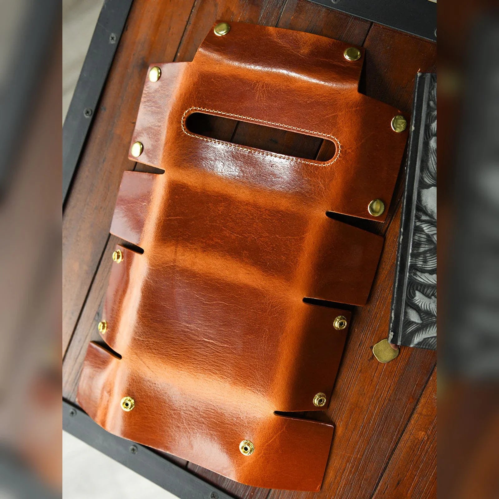 Unfolded leather tissue box cover showing snap construction