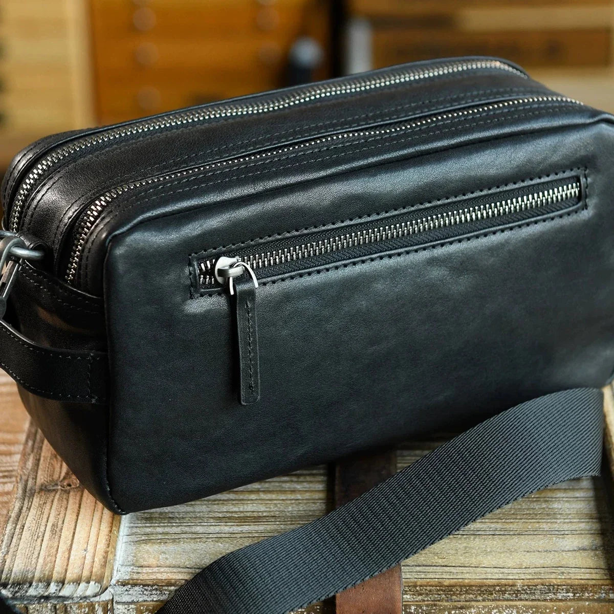 Rear zipper pocket and stitched leather construction detail