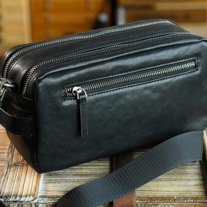 Rear zipper pocket and stitched leather construction detail