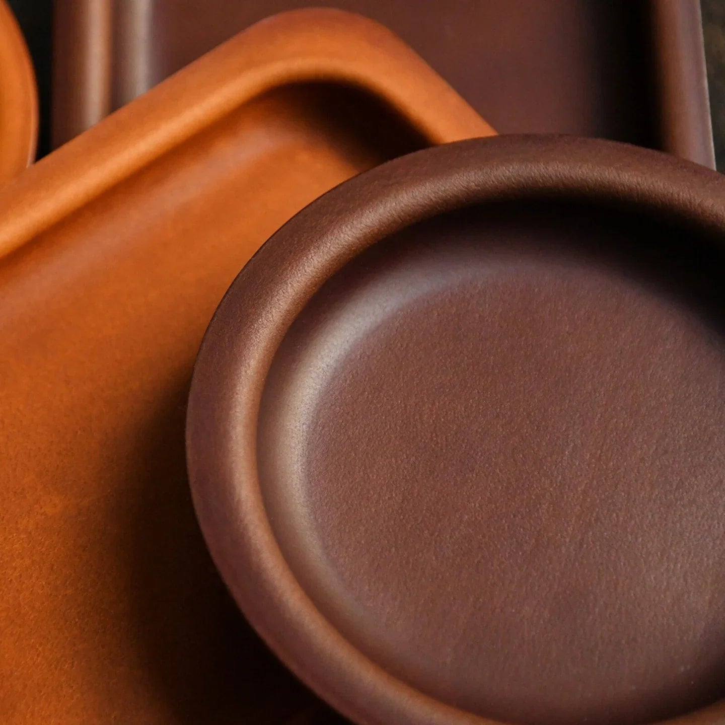 Round and square cowhide valet trays in Brown and Coffee Brown