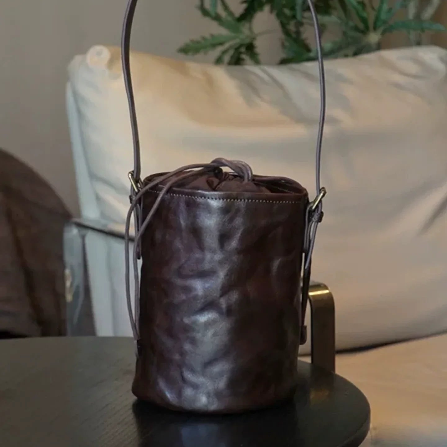 Full view of the ebony brown top-grain leather bucket bag