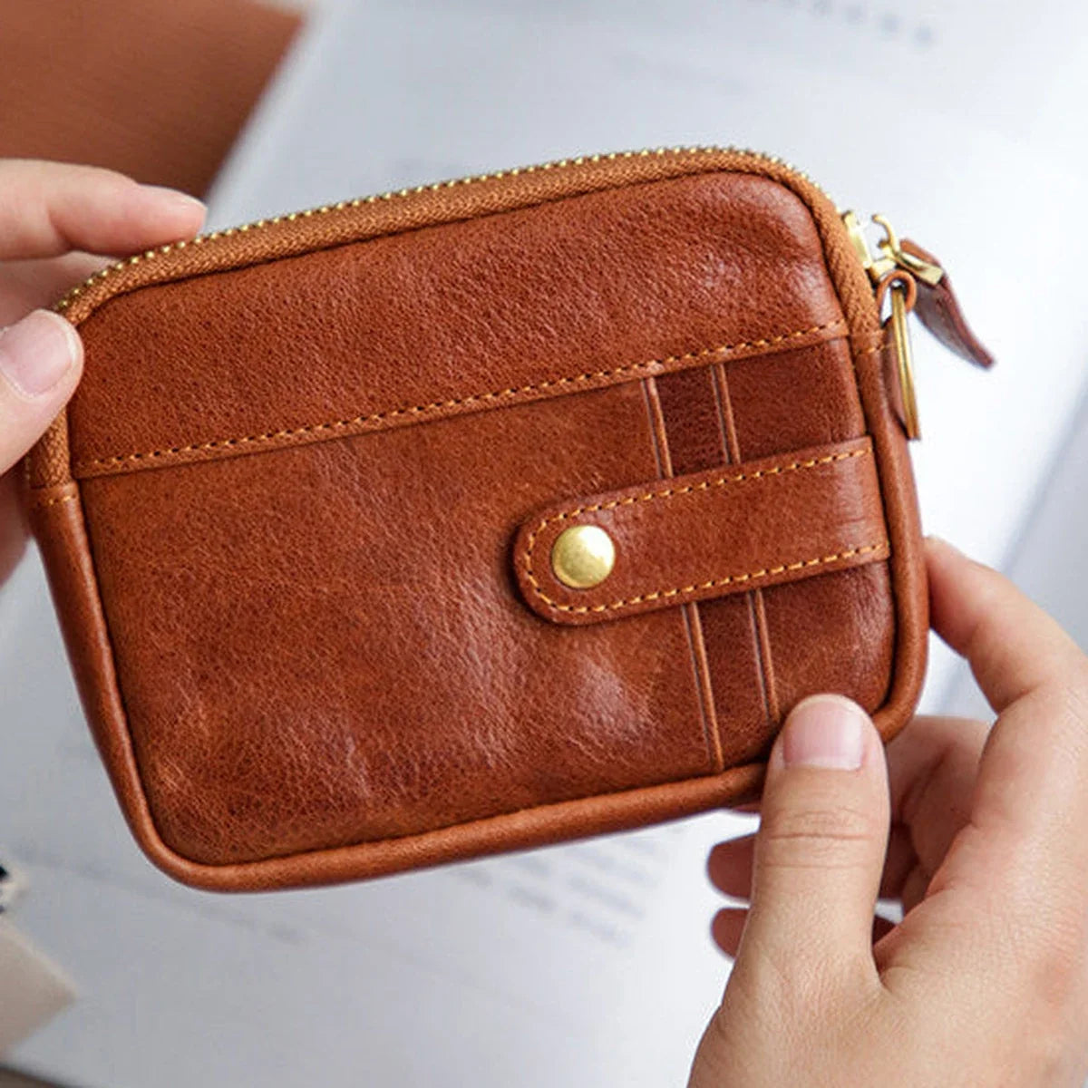Close view of vegetable-tanned leather grain, stitching, and brass-tone hardware