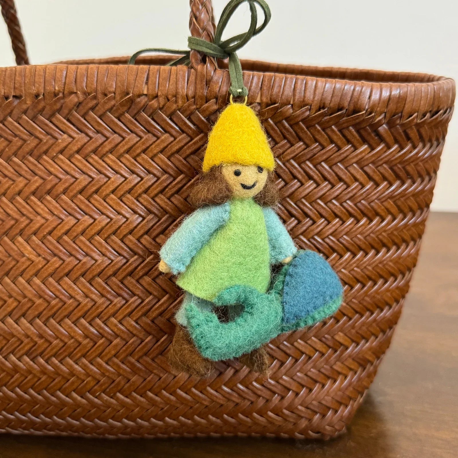Alternate construction view of the handmade wool felt girl and beetle charm