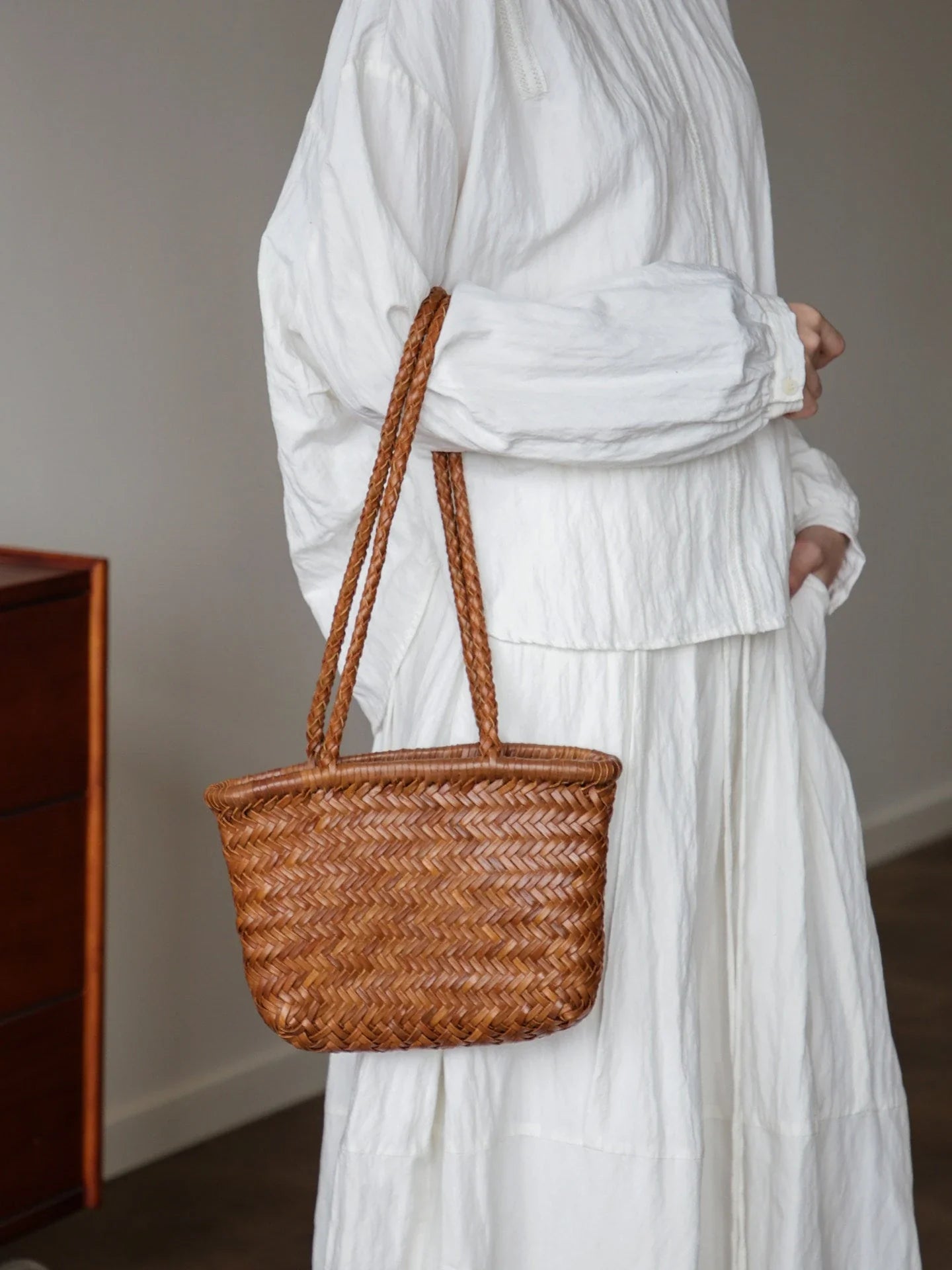 Brown woven leather shoulder bag shown from the front