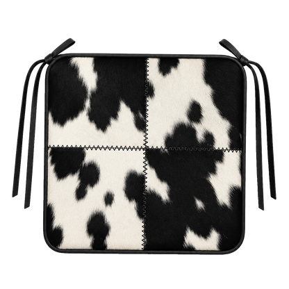 Black and ivory genuine cowhide patchwork square chair pad with leather border and tie straps on transparent background