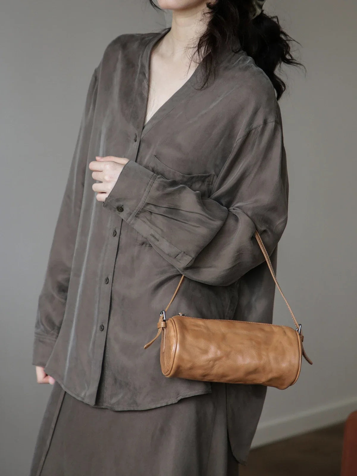 Chestnut leather barrel shoulder bag worn at the side