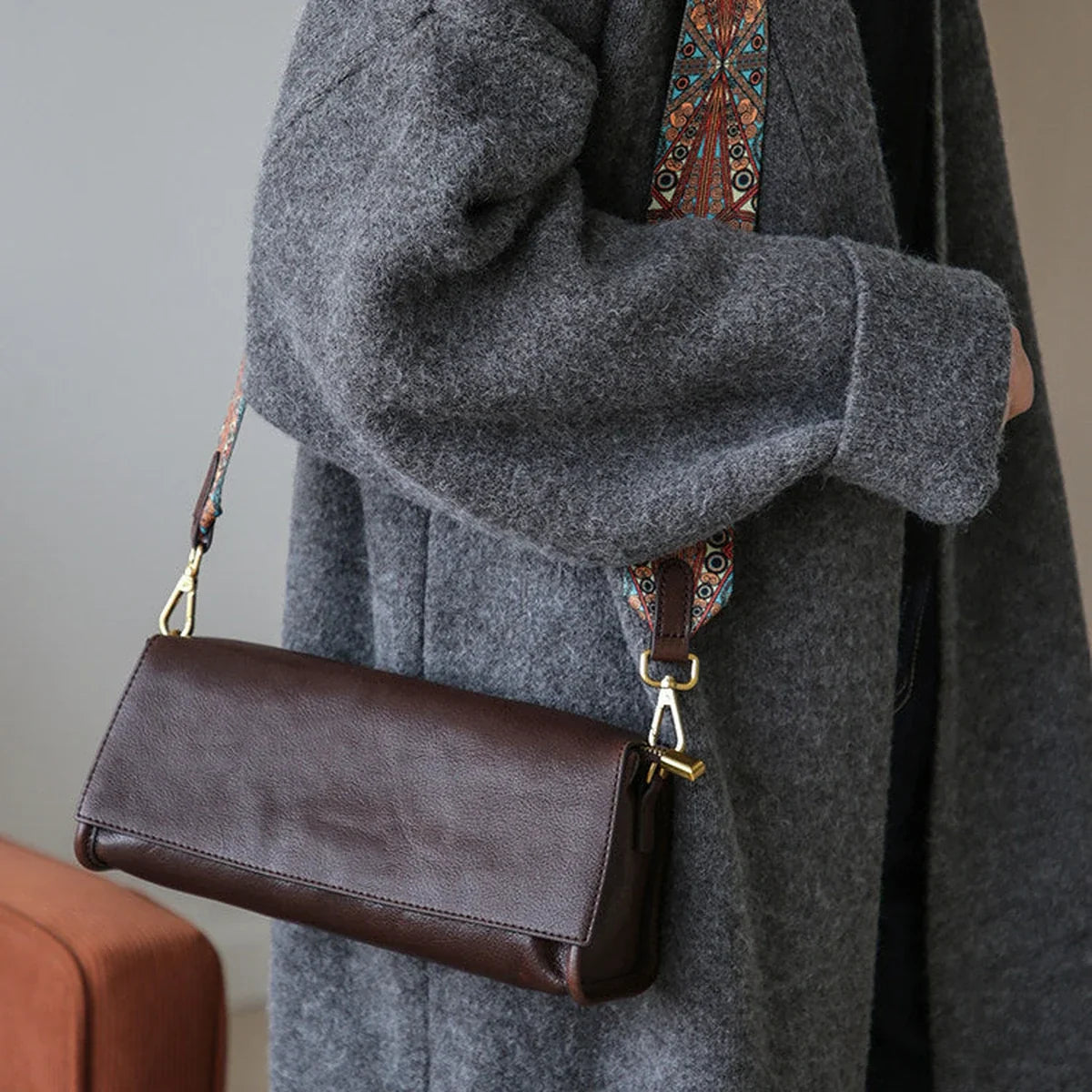 Coffee brown leather shoulder bag with a woven strap