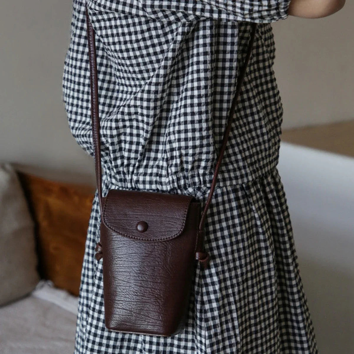 Women's coffee brown leather phone crossbody bag in a casual styling view